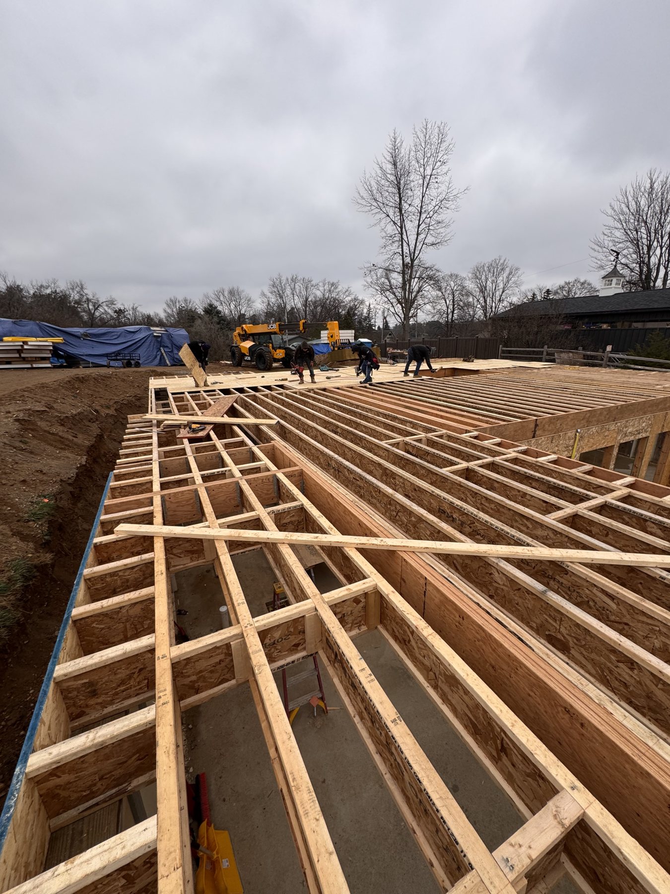 Crew installing the floor system on a new home