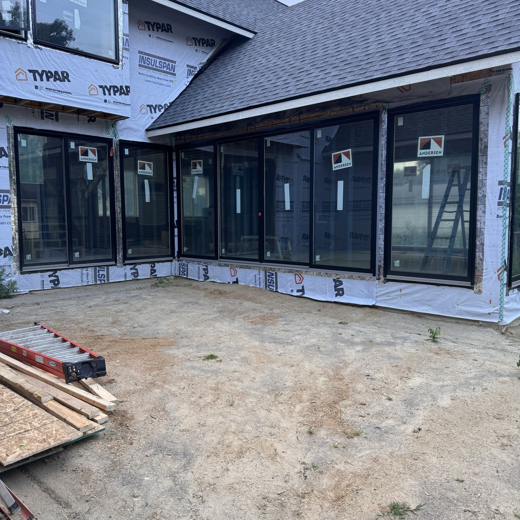 High-performance window wall on a new home, wrapped and sealed