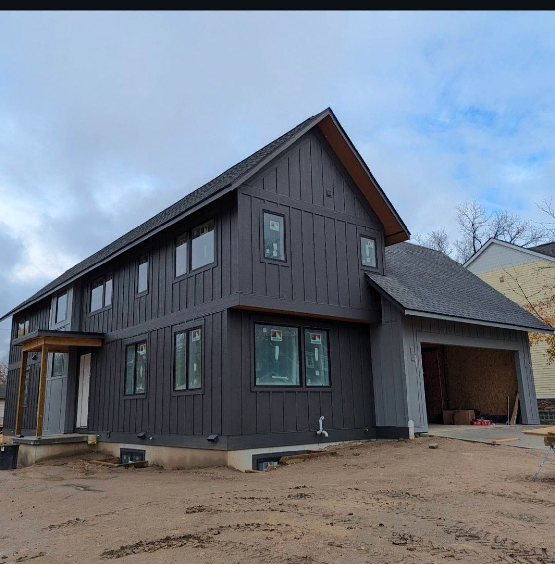 Modern new home with dark board and batten siding